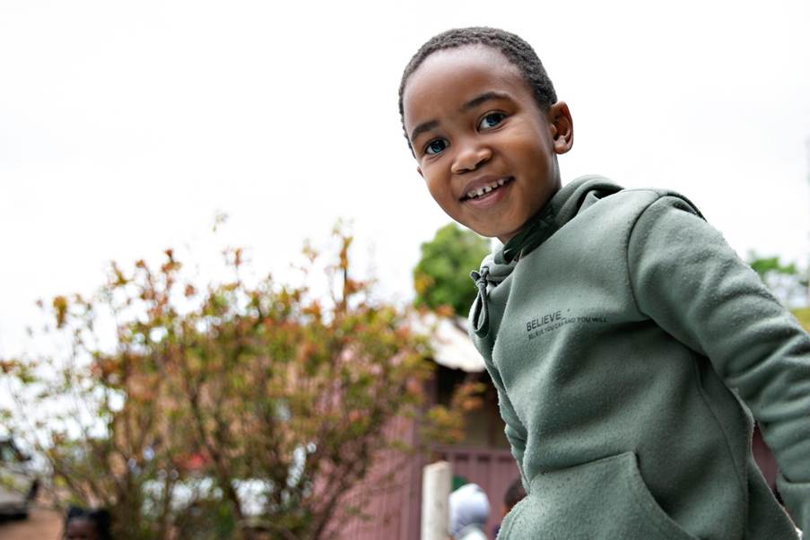 A young child smiling at the camera

AI-generated content may be incorrect.