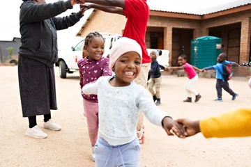 Children in play line hand in hand