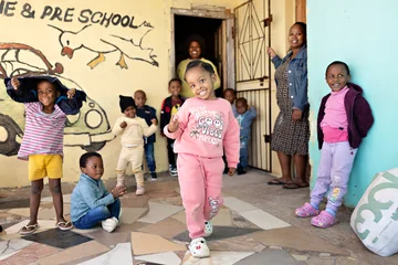 ECD child walking, children in background
